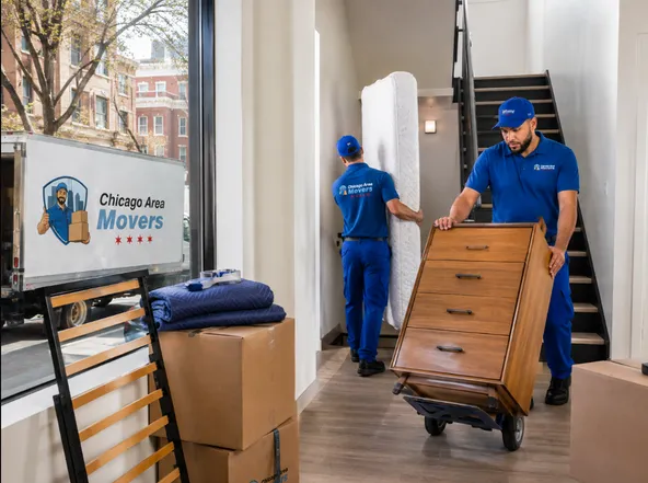 Movers wheeling a dresser down a stairwell for storage